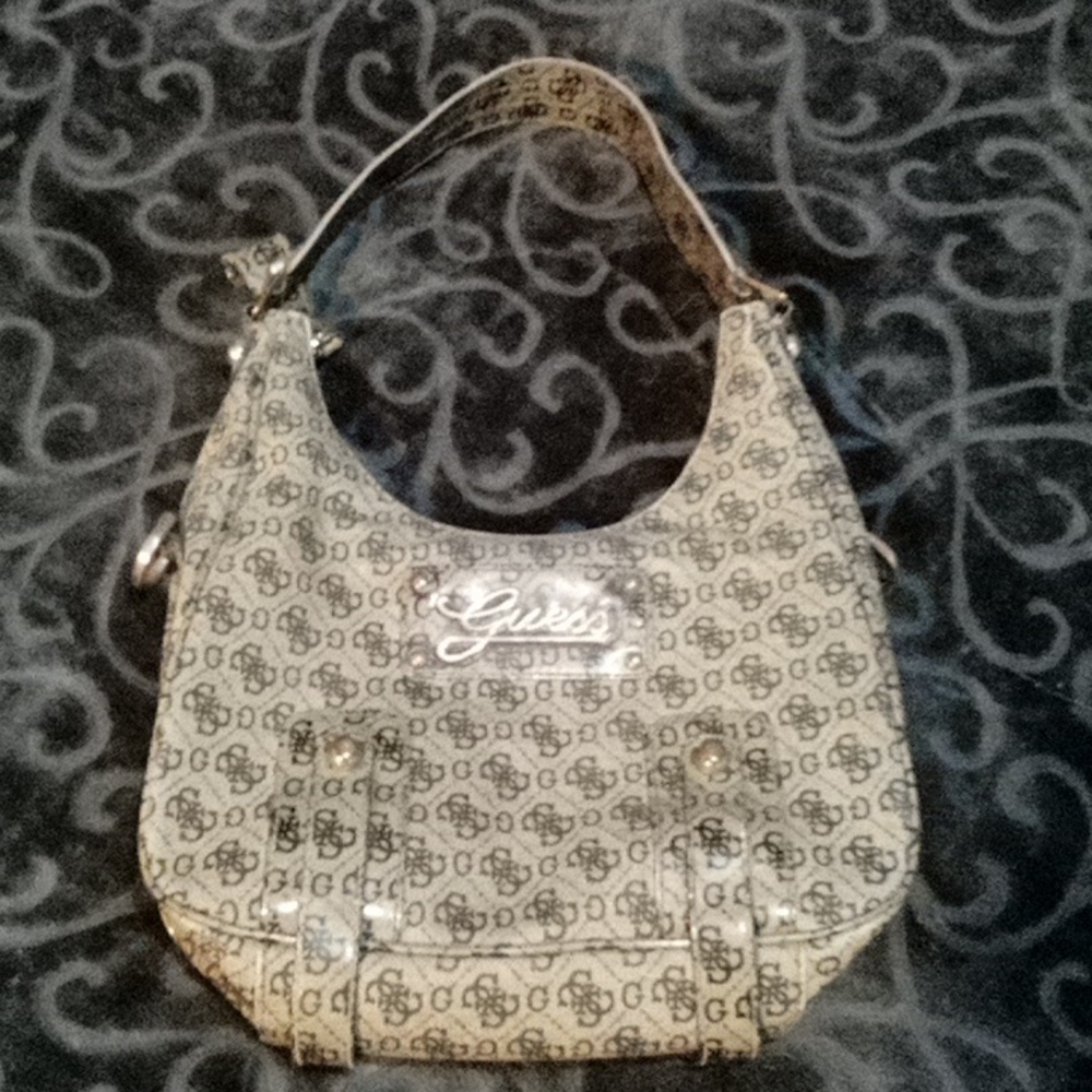 Beige in color Guess hand bag